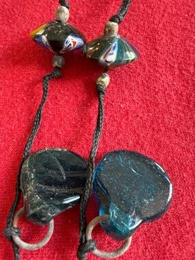 artistic. stones, metal rings? glass ornaments, necklace.